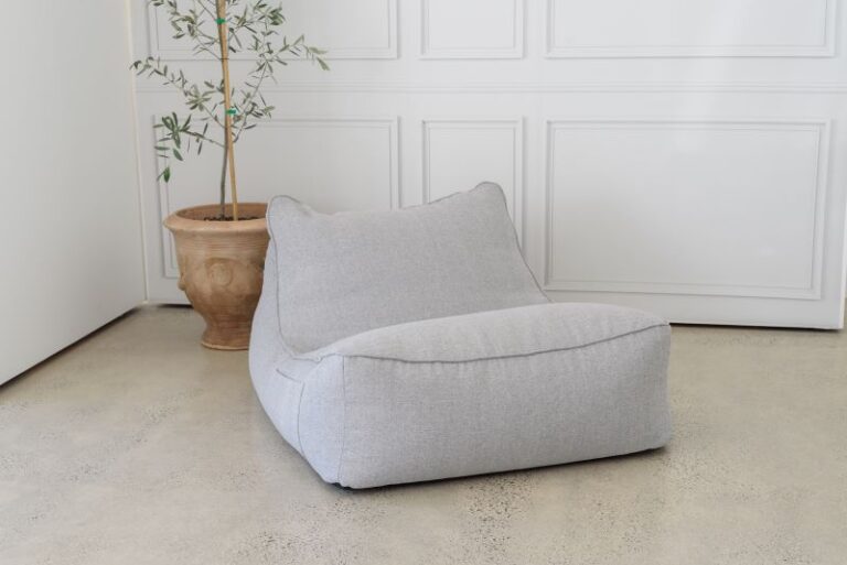 Lounger Bean bag in a room corner near an olive plant