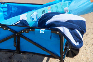 Close up of a towel and sun shelter in a blue LiFE! Beach Cart sold at Decathlon